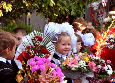 First graders give flowers to their teachers on the 1st of September
