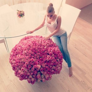 Russian woman posing with gigantic bouquet of flowers