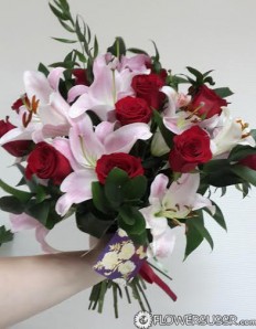 Bouquet of red roses, lilies and greens delivered to St. Petersburg